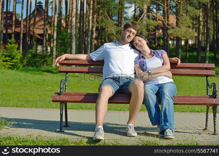 Portrait of romantic young couple in love smiling together outdoor in nature with blue sky in background