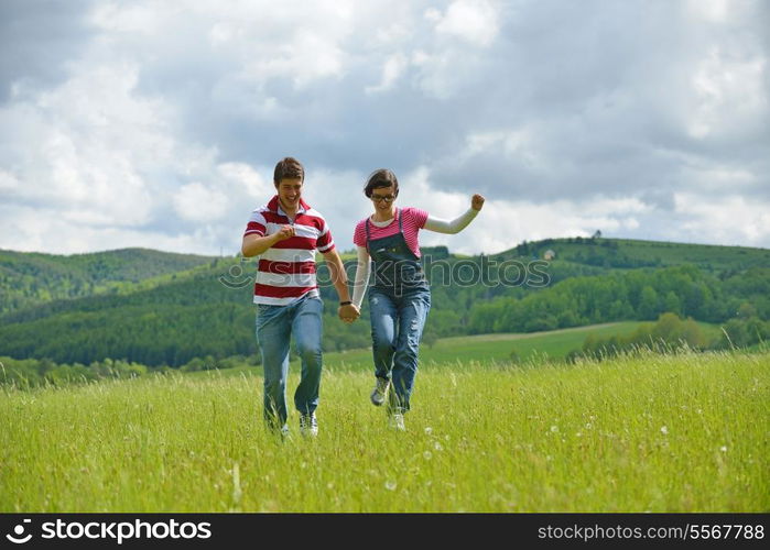 Portrait of romantic young couple in love smiling together outdoor in nature with blue sky in background