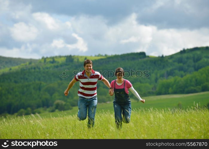 Portrait of romantic young couple in love smiling together outdoor in nature with blue sky in background