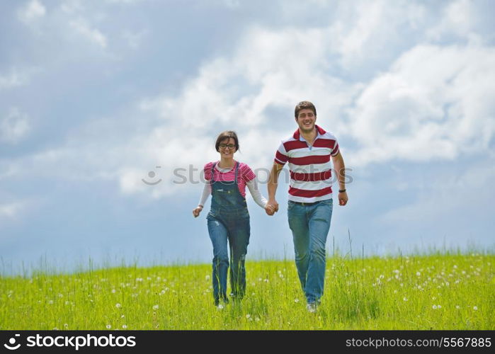 Portrait of romantic young couple in love smiling together outdoor in nature with blue sky in background