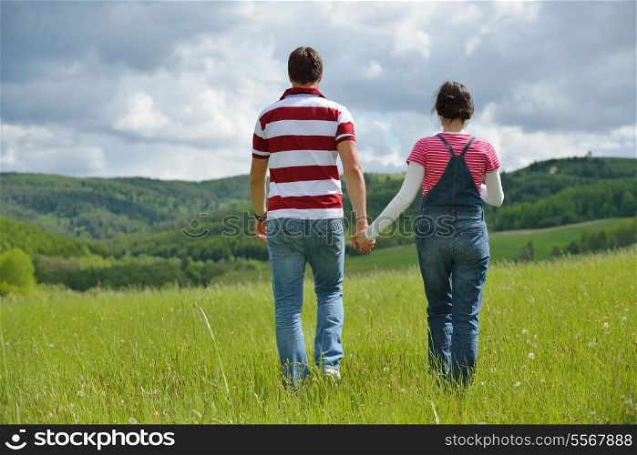 Portrait of romantic young couple in love smiling together outdoor in nature with blue sky in background