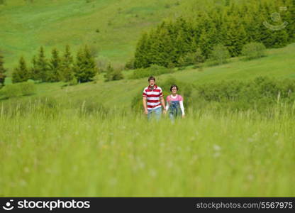 Portrait of romantic young couple in love smiling together outdoor in nature with blue sky in background