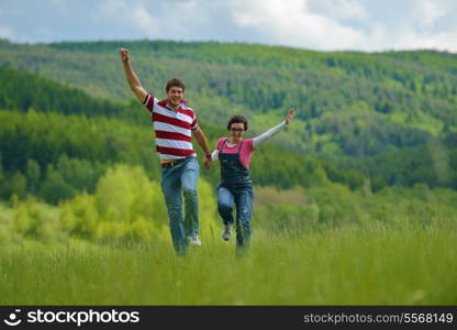 Portrait of romantic young couple in love smiling together outdoor in nature with blue sky in background