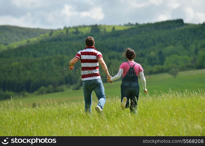 Portrait of romantic young couple in love smiling together outdoor in nature with blue sky in background