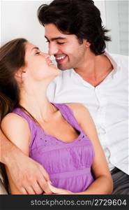 portrait of romantic young couple kissing eachother in causel wear