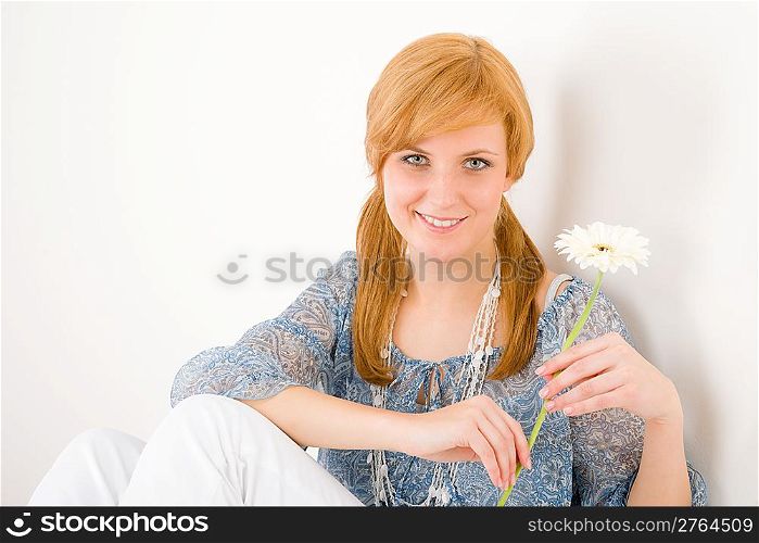 Portrait of romantic young happy woman hold gerbera daisy
