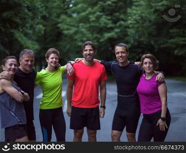 portrait of runners team on morning training. portrait of a group healthy people jogging in city park, runners team on morning training
