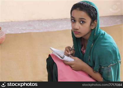 Portrait of rural girl studying