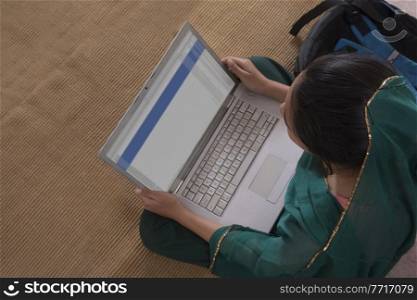 Portrait of rural girl using laptop