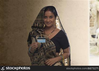 Portrait of rural woman holding credit card