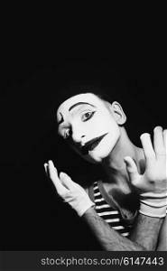 Portrait of sad mime on black background