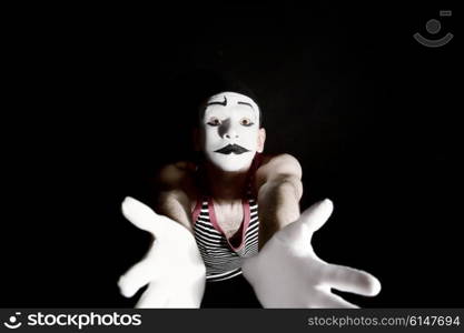 Portrait of sad mime on black background