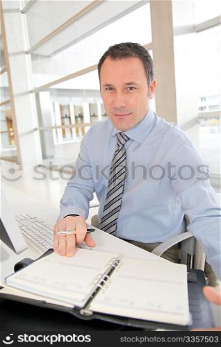 Portrait of salesman writing on agenda