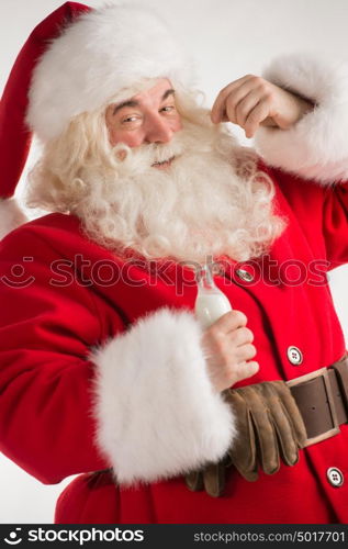 Portrait of Santa Claus Drinking milk from glass bottle. Greeting card background