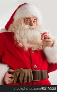 Portrait of Santa Claus Drinking milk from glass. Greeting card background
