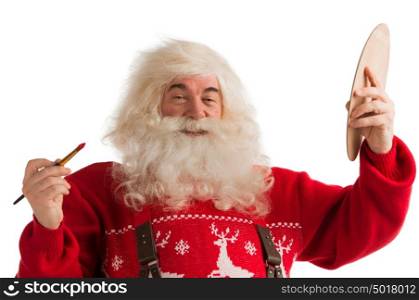 Portrait of Santa Claus painting with brush and palette isolated on white background