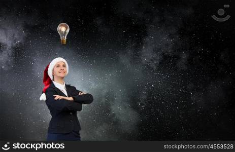 Portrait of Santa woman. Woman in suit and Santa hat with arms crossed on chest