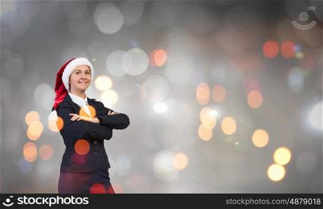 Portrait of Santa woman. Woman in suit and Santa hat with arms crossed on chest