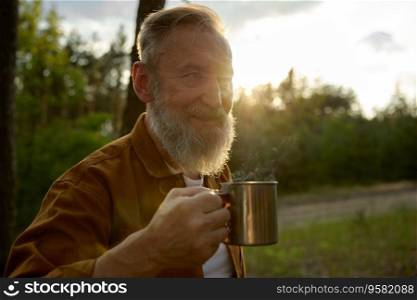 Portrait of satisfied retired man drinking hot steaming coffee or tea over morning natural background. Countryside recreation activity enjoyment on retirement. Portrait of satisfied retired man drinking hot steaming coffee or tea