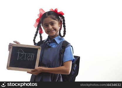 Portrait of school girl holding slate