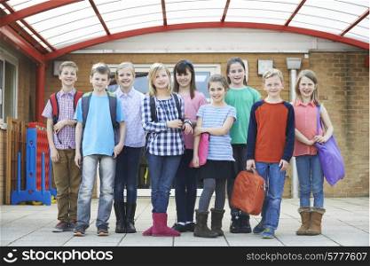 Portrait Of School Pupils Outside Classroom Carrying Bags