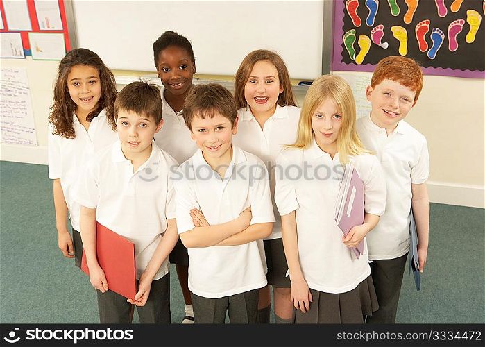 Portrait Of Schoolchildren Standing In Classroom
