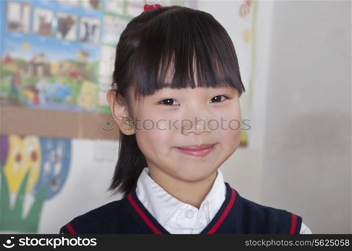 Portrait of schoolgirl in classroom, Beijing, China