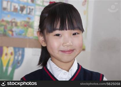 Portrait of schoolgirl in classroom, Beijing, China