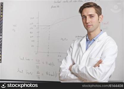 Portrait Of Science Teacher Standing In Front Of Whitebaord