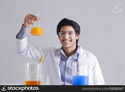 Portrait of scientist holding flask