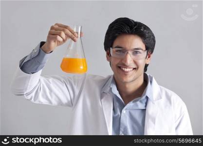 Portrait of scientist holding flask