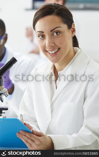 Portrait Of Scientist With Clipboard In Laboratory