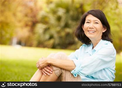 Portrait Of Senior Asian Woman Sitting In Park