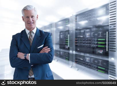 Portrait of senior businessman in big rack server room