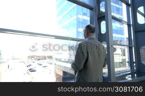 Portrait of senior businessman looking at window and thinking