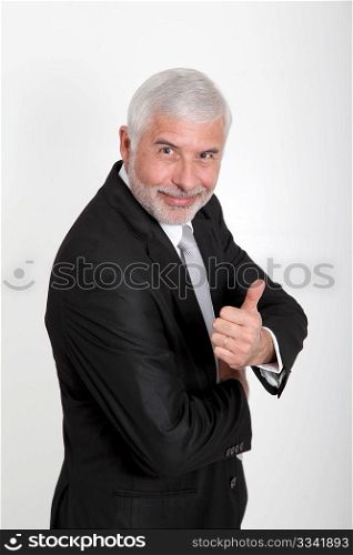 Portrait of senior businessman showing thumbs up