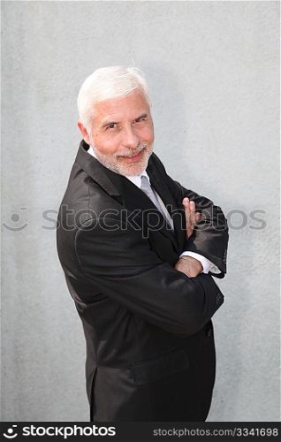Portrait of senior businessman standing outdoors