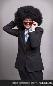 Portrait of senior businesswoman wearing wig and eyeglasses in studio