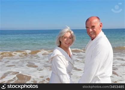 Portrait of senior couple relaxing on a resort beach