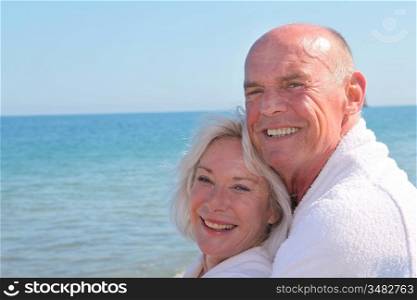Portrait of senior couple relaxing on a resort beach