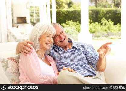 Portrait Of Senior Couple Relaxing Together On Sofa