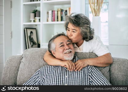 Portrait of senior couple sitting on sofa in living room