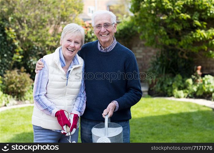 Portrait Of Senior Couple Working In Garden Together