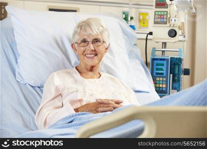 Portrait Of Senior Female Patient Relaxing In Hospital Bed