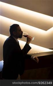 Portrait of senior handsome man drinking red wine