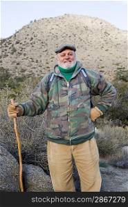 Portrait of senior male hiker holding hiking pole