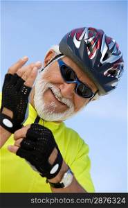 Portrait of Senior man adjusting cycling gloves