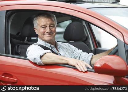 Portrait Of Senior Man Driving Car