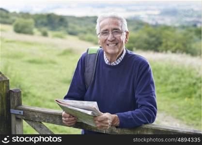 Portrait Of Senior Man Hiking In Countryside