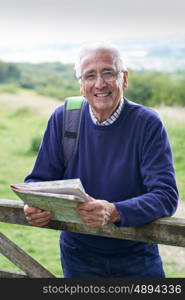 Portrait Of Senior Man Hiking In Countryside